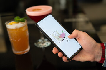 beautiful and delicious alcoholic cocktails prepared at the bar by the bartender.