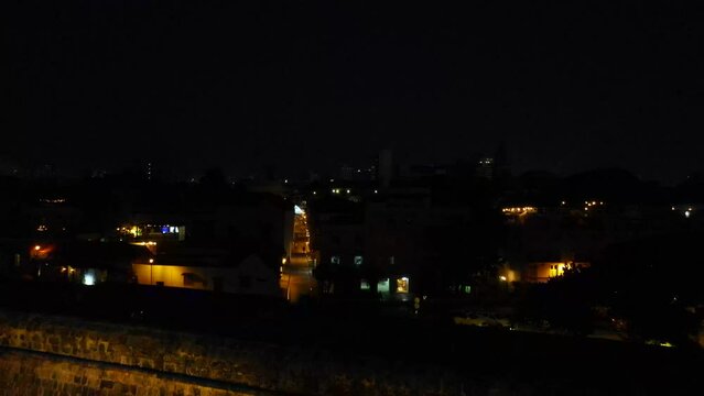 Aerial shot drone at night descends over baluarte de santo domingo