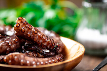 An octopus on a wooden plate. 