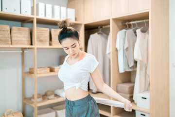 beautiful woman stretching body using cloth in dressing room. motivated woman stretching exercising holding towel with healthy concept. pretty woman balance body holding cloth relax control breathing