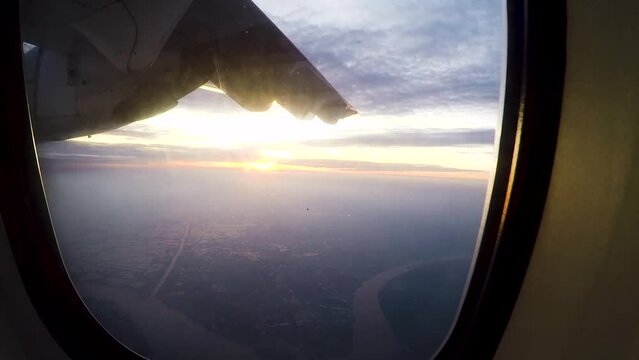 a propeller plane in the sky after take off and landing with the sunset