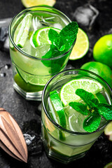 Traditional mojito with pieces of lime and mint. 