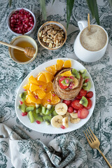 Pancakes with fresh fruit. Fruit salad with gluten-free pancakes. Healthy breakfast full of vitamins