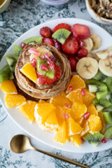 Pancakes with fresh fruit. Fruit salad with gluten-free pancakes. Healthy breakfast full of vitamins