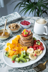 Pancakes with fresh fruit. Fruit salad with gluten-free pancakes. Healthy breakfast full of vitamins