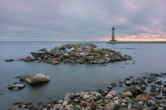 The old lighthouse in the Baltic Sea at dawn photographed on long exposure