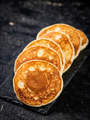 Ready made homemade pancakes on a stone board. 