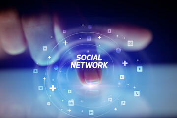 Finger touching tablet with social media icons concept