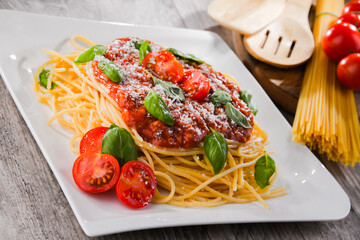 Composition with a plate of spaghetti bolognese