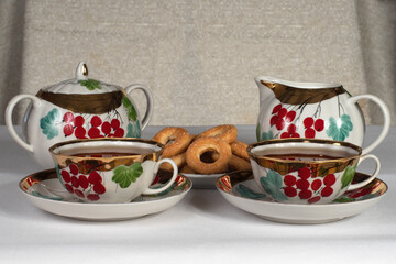 tea set with cookies on a white tablecloth
