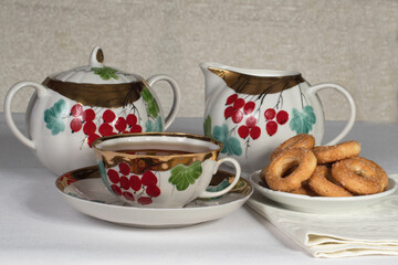 tea set with cookies on a white tablecloth