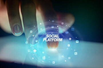 Finger touching tablet with social media icons concept