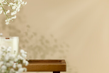 Wooden empty podium for beauty or spa products, cosmetics on natural beige background with flowers...