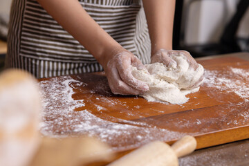 Woman Hand Kneaded Fresh Raw Dough on the Wooden Board