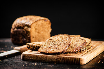 Sliced rye bread on a cutting board. 