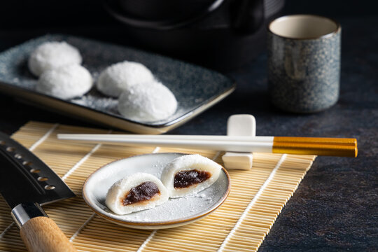 Japanese Mochi with a red bean filling on a Japanese style table top.