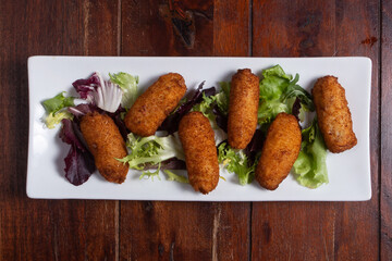 Potato croquettes, tipical spanish dish, tapas en restaurant.