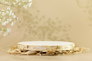 Wooden empty podium on natural beige background with white flowers and shadows. Round show case for...