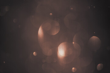 Golden lights bokeh background. Abstract blurred glowing lights