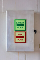 A fire safety plan box on a white wall with information for fire fighters on a cruise ship