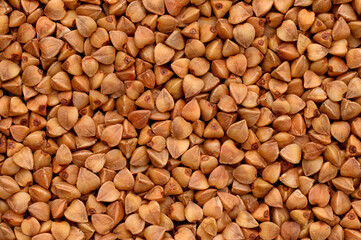 Close-up of buckwheat, top view.Texture, dry buckwheat background. Hypoallergenic filler for pillows. Prevention of anemia, diabetes. 