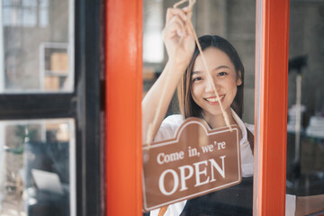 Opening a small business, Happy Asian woman in an apron standing near a bar counter coffee shop, Small business owner, restaurant, barista, cafe, Online, SME, entrepreneur, and seller concept.
