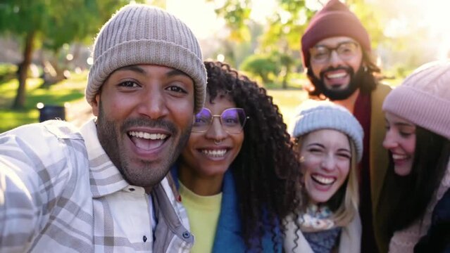 Multiethnic friends taking selfie smiling happy looking at camera having fun together. Concept of diverse community and friendship. African, caucasian and latin people High quality photo