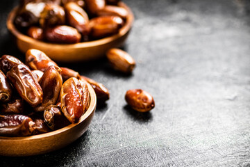 Two plates of dates on the table. 