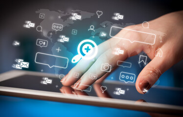 Close-up of a hand using tablet, social media concept