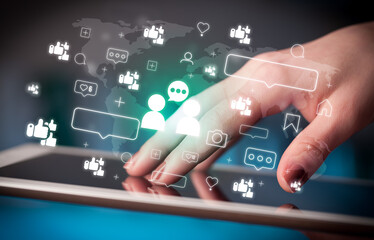 Close-up of a hand using tablet, social media concept