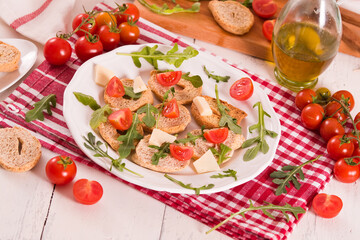 Friselle with cherry tomatoes and arugula.