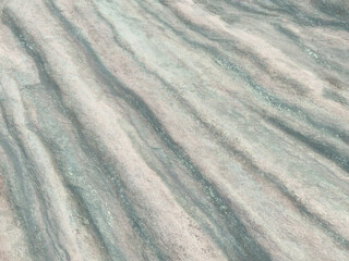 Fototapeta premium Abstract grunge painting background design, ripples of stone texture. Charcoal, chalk, paint on canvas. Warm color tones. Rough grain, course gritty, masculine, strong, powerful, hard.