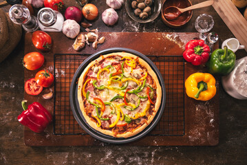 Top view of pizza ingredients and spices preparation on wood table, Homemade pizza cooking in the kitchen at home.