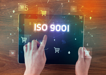 Close-up of a hand holding tablet with shopping inscription