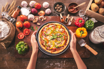 Top view of pizza ingredients and spices preparation on wood table, Homemade pizza cooking in the kitchen at home.
