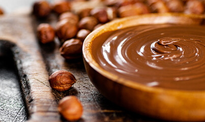 Hazelnut butter in a plate on a cutting board. 