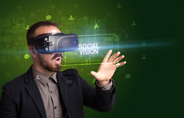 Businessman looking through Virtual Reality glasses, social media concept