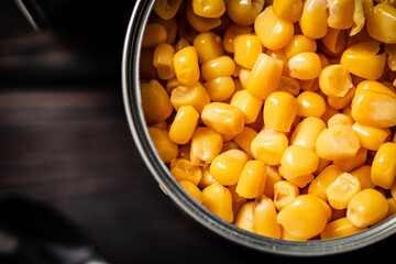 An open can of canned corn. 