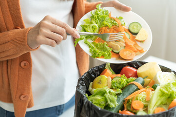 Compost from leftover food, asian young housekeeper woman hand holding cutting board use fork...