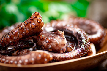 An octopus on a wooden plate. 