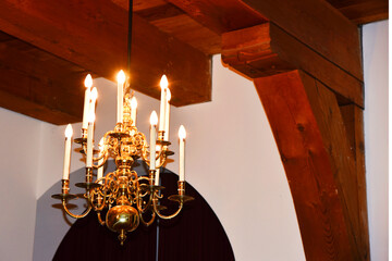 Alkmaar, Netherlands. January 2023. Old beamed ceiling with chandelier.