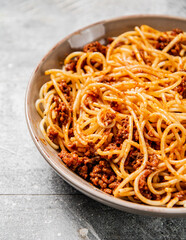 Homemade spaghetti bolognese. On a gray background.