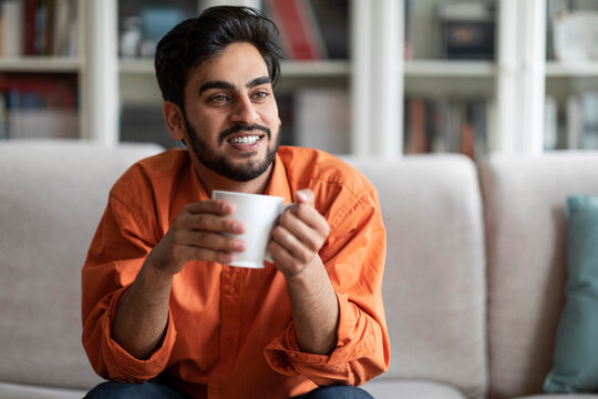 Cool Middle Eastern Man Enjoying Morning Coffee At Home