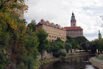 A large castle built on an elevated river bank. Historical building.