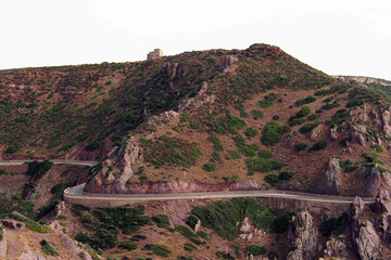 A view of the road stretching around the mountain. Sardinia, little green.