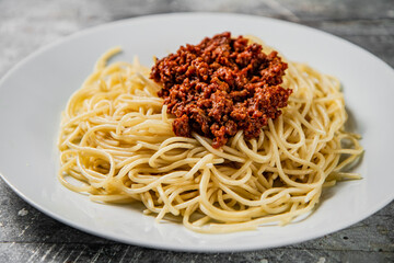 Homemade spaghetti bolognese. On a gray background.