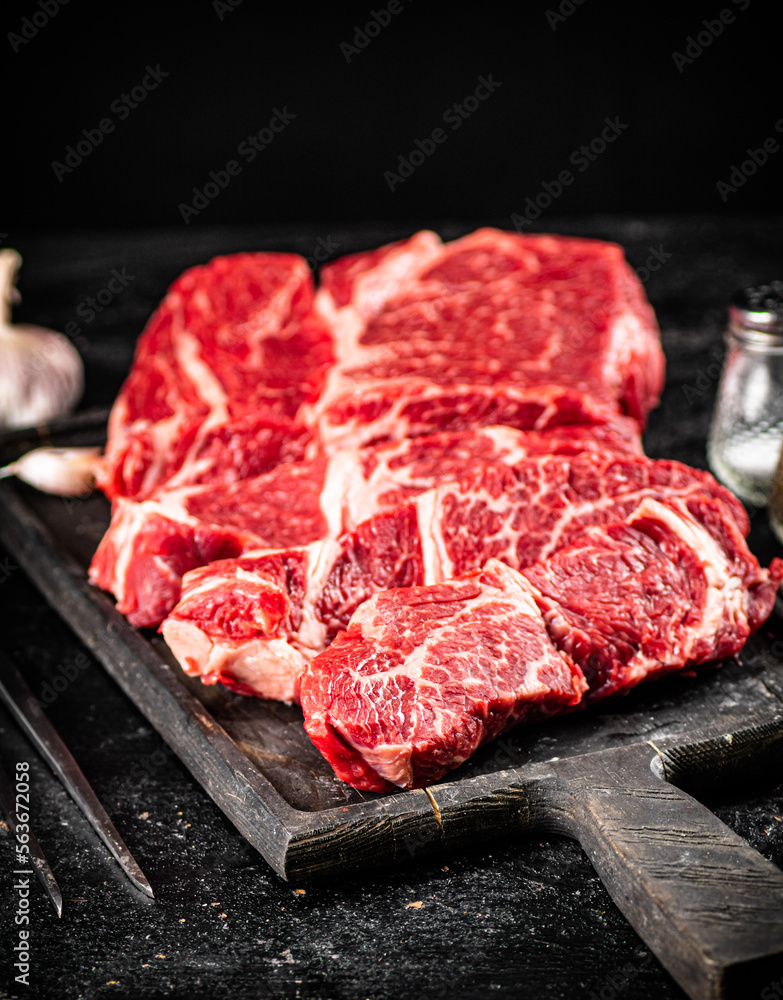 Poster Raw beef on a cutting board. 