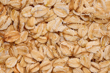 Macro photo of oatmeal. Texture, background of dry oatmeal.Healthy, delicious food, source of amino acids,minerals.
