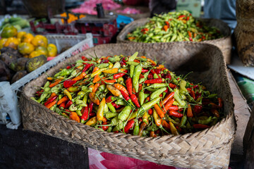 A basket full of fresh Indonesian chilli peppers, also called rawit or bird's eye chili