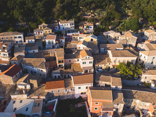 Fototapeta premium Beautiful aerial drone view of Lakones Village, traditional greek village near Paleokastritsa, Corfu island, Kerkyra, Ionian sea islands, Greece, in summer sunny day with blue sky and mountains